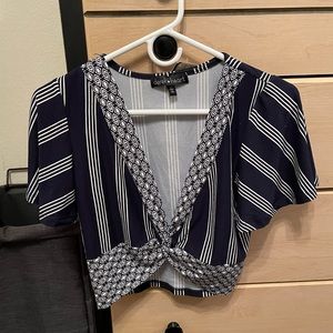Navy blue and white patterned blouse